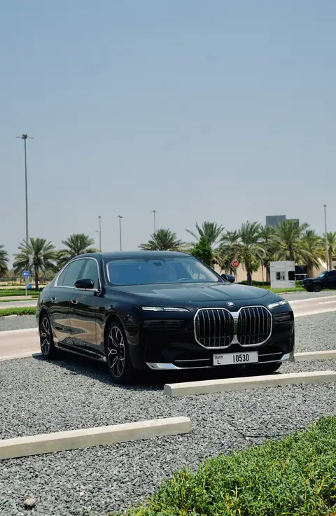 A black BMW 7 Series in front of the Sheikh Zayed Grand Mosque