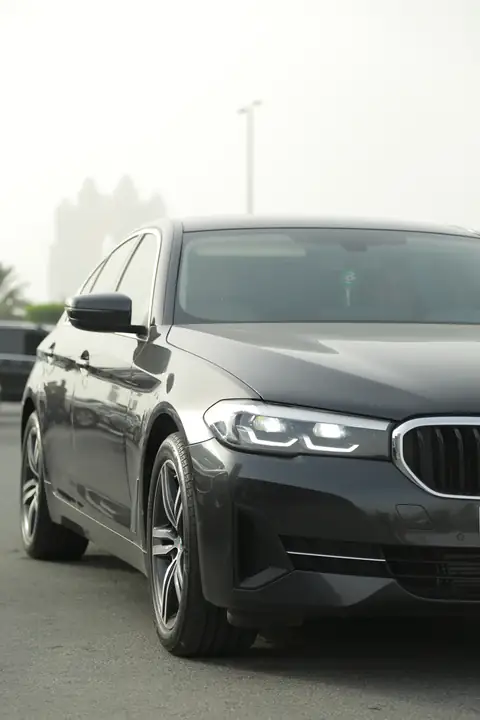A black BMW sedan from the front quarter