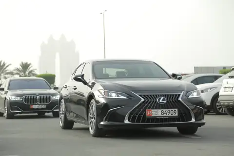 A black Lexus ES from the front quarter in sunlight