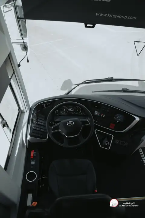 A coach's driving seat and wheel seen from the door
