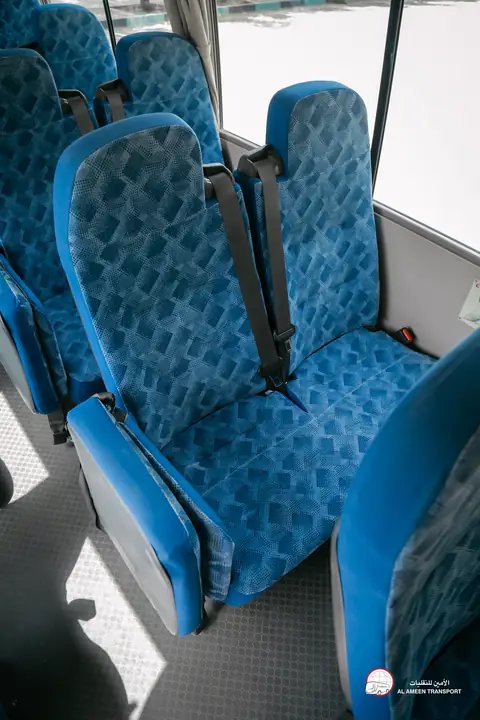 A minibus seat in blue patterned upholstery, close up