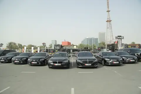 A row of black BMW sedans with their fronts to the camera