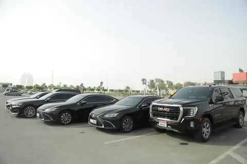 A row of black chauffeur cars from the front quarter