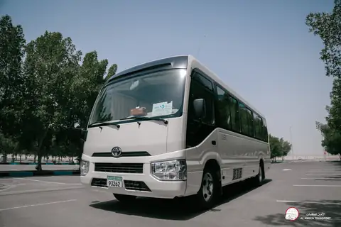 A white Toyota minibus from the front quarter