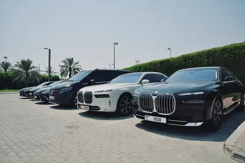 Chauffeur cars in a row with a white BMW 7 Series in front