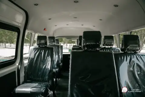 Inside a van: rows of seats in protective covers