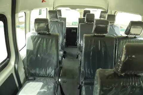 Inside a van: seats in protective covers back to the rear row