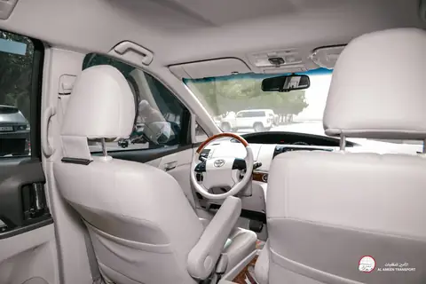 Inside an MPV: cream leather seats and the driver's wheel