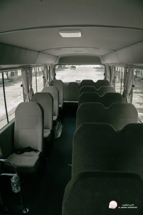 Rows of pale seats inside a minibus