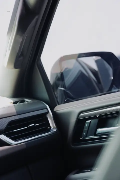 The door and wing mirror of a black SUV