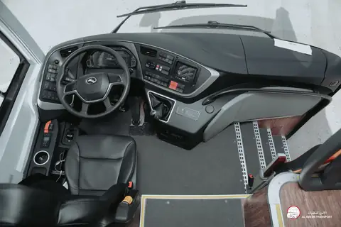 The driver's cab of a coach: the wheel, the dashboard and the steps up to the seats