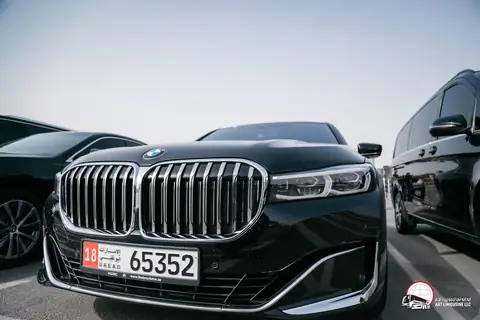 The grille of a black BMW 7 Series on UAE plates, close up