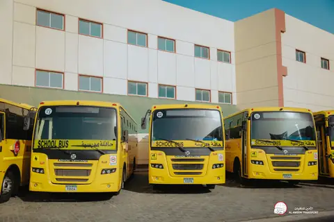 Three yellow school buses side by side with their fronts to the camera