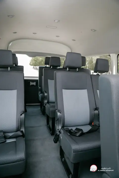 Two rows of grey seats inside a van